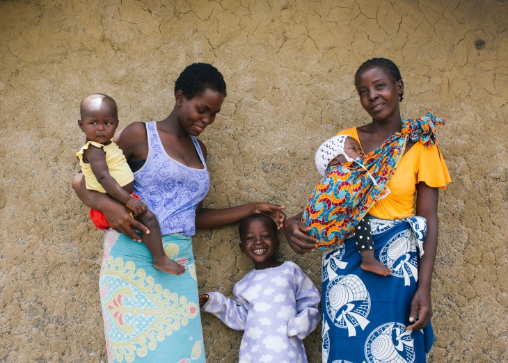 Antonia, 29, in blue skirt (Cupolana) material given as part of Oxfam kit in June 2019.  Daughter Josephina*, 1, and son Pedro*, 4. Josephina is carried in a sling made from a Cupolana she was given by Oxfam.