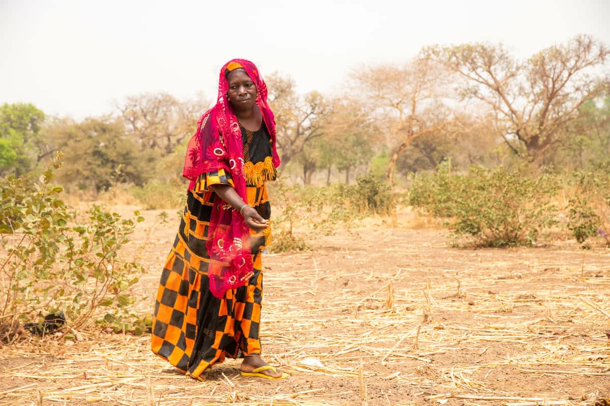 Woman in dried out landscape, Burkina Faso 2022