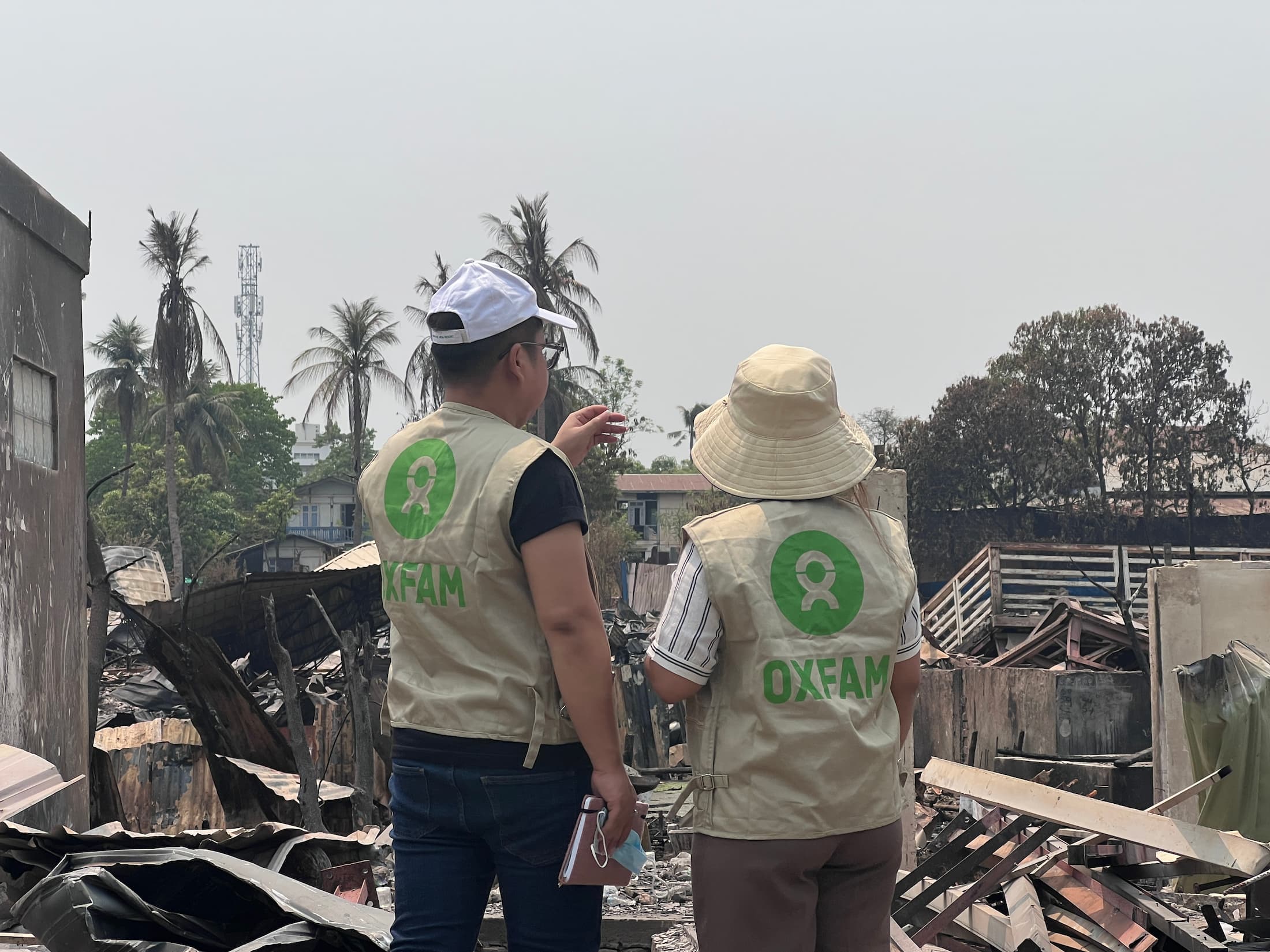 Oxfam staff discussion about the devastation at the areas they are visiting in Mandalay